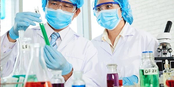 Engineers analyzing chemicals filtered by a Chemical Dosing Pump